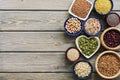 A set of various superfoods Ã¢â¬â whole grains,beans, seeds, legumes in bowls on a wooden plank table. Top view, copy space